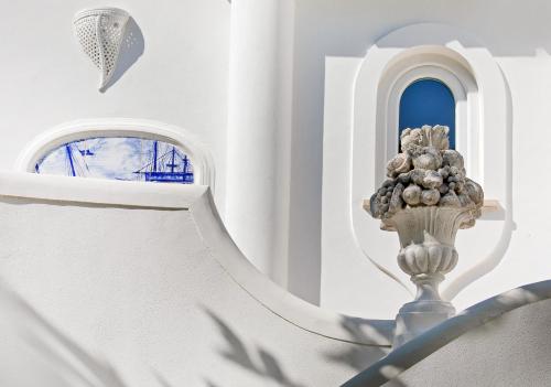 a white staircase with a vase of flowers on it at Casa Gaia in Capri