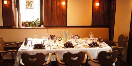 a table in a room with a white table cloth and chairs at Hotel-Restaurant Sonne in Talheim
