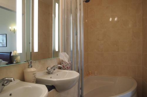 a bathroom with a sink, toilet and bathtub at Thistle Hotel in Edinburgh