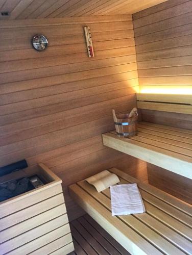 a sauna with wooden paneled walls and wooden shelves at Aparthotel Albatros in Lignano Sabbiadoro