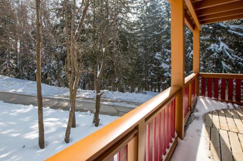 a porch of a house with snow on the ground at Bolfenk lodge apartment in Pohorje