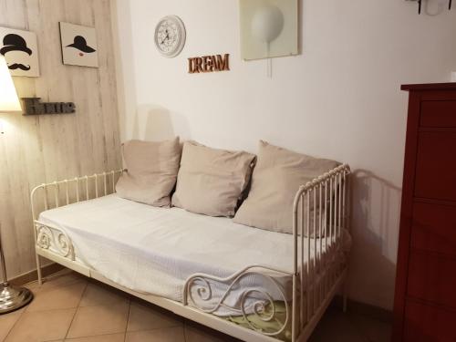 una cuna blanca con almohadas en una habitación en Tabor 1 casa vacanza in villa, en Nápoles