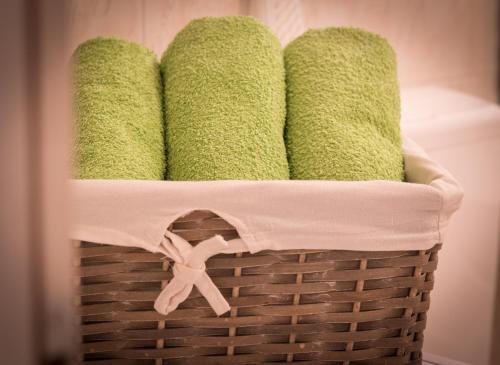 a basket filled with green towels in a bathroom at Apartment Ivana in Makarska