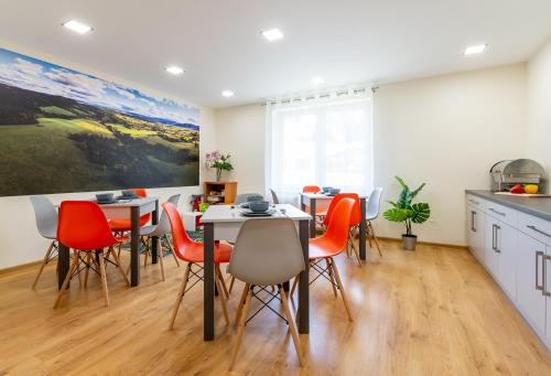 a kitchen and dining room with tables and chairs at Apartament i Pokoje Gościnne u Lusi in Wisła