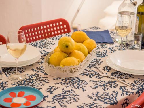 a bowl of lemons sitting on top of a table at Rundanina Village Life Studio in Vernazza