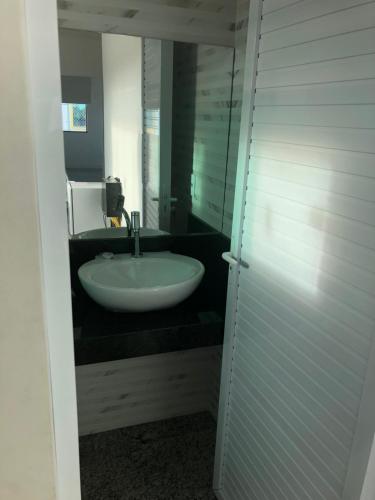 a bathroom with a sink and a mirror at Pousada Barreirinhas in Barreirinhas