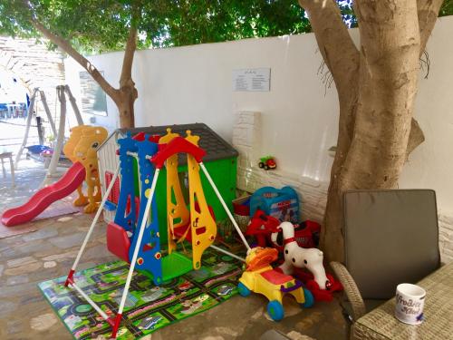 a bunch of toys sitting next to a tree at Aphrodite Boutique Hotel in Aliki