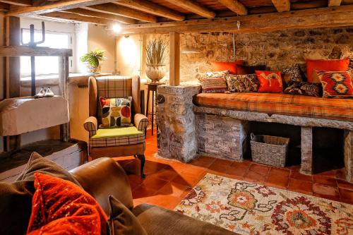 a living room with a couch and a fireplace at The Cheese House, Gileston Manor in Gileston