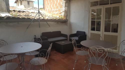 a room with two tables and chairs and a couch at Chez Albert et Karine in Sauve