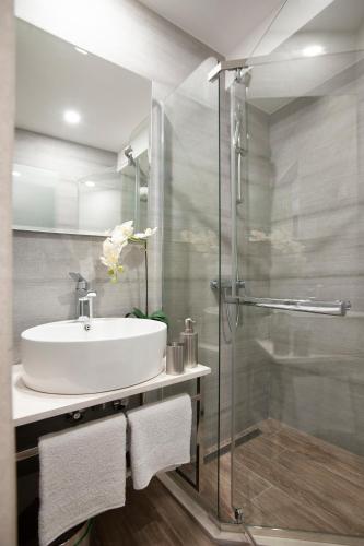 a bathroom with a sink and a glass shower at Casa Mia in Budva