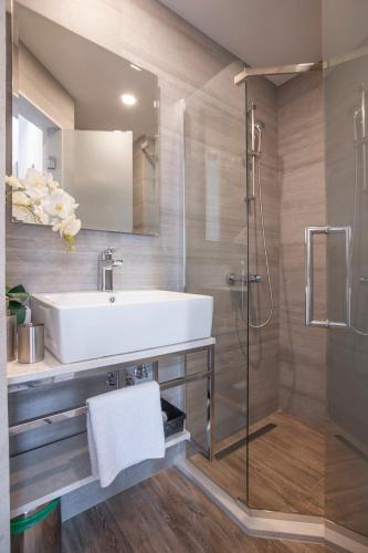 a bathroom with a sink and a shower at Casa Mia in Budva