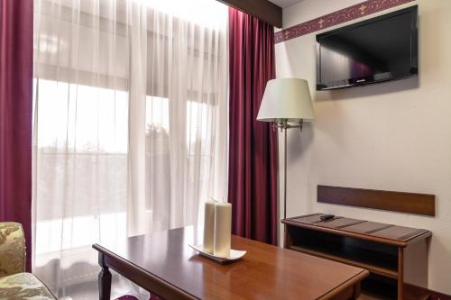 a hotel room with a table and a window at SPA Amber Palace in Šventoji