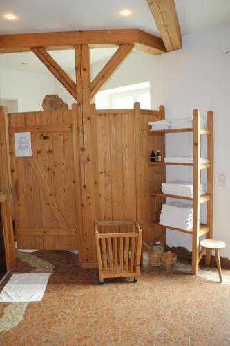 a room with a wooden barn door and a shelf at Hotel Almtalerhof in Linz