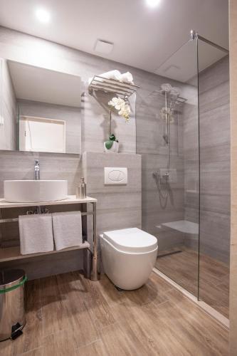 a bathroom with a sink and a toilet and a shower at Casa Mia in Budva