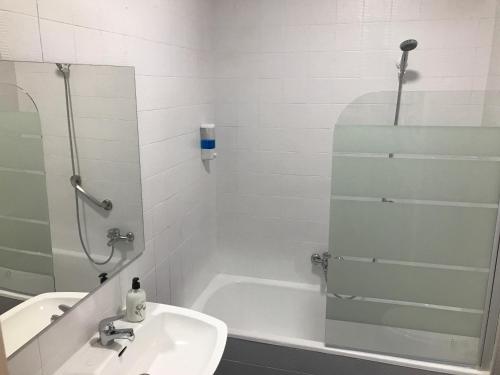 a bathroom with a sink, toilet and shower stall at Hotel Playa San Cristóbal in Almuñécar