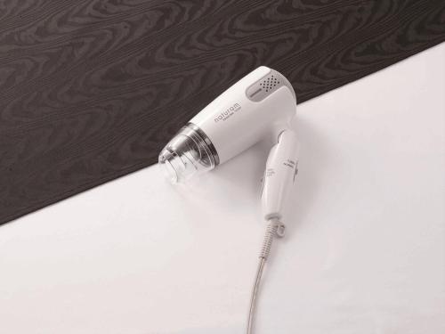 a white electric hair dryer sitting on a table at APA Hotel Kyoto Ekimae in Kyoto