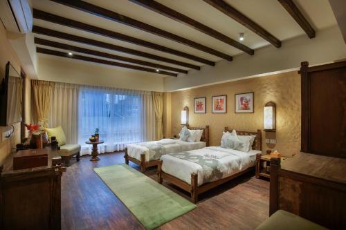 a large bedroom with two beds and a window at Hotel Thamel House - 6 km from Boudhanath Stupa, Kathmandu in Kathmandu