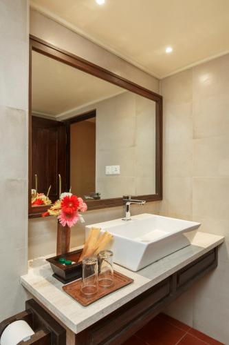 a bathroom with a sink and a large mirror at Hotel Thamel House - 6 km from Boudhanath Stupa, Kathmandu in Kathmandu