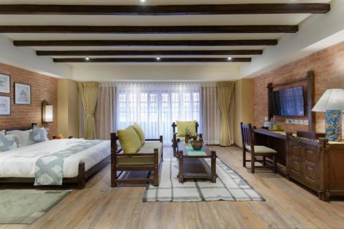 a hotel room with a bed and a desk and a table at Hotel Thamel House - 6 km from Boudhanath Stupa, Kathmandu in Kathmandu