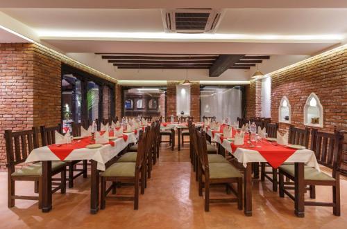 a restaurant with long tables and chairs with red napkins at Hotel Thamel House - 6 km from Boudhanath Stupa, Kathmandu in Kathmandu