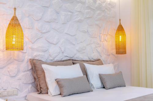 a room with a couch with pillows against a wall at Naxian Pearl in Mikri Vigla