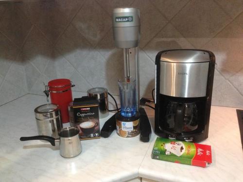 a kitchen counter with a coffee maker and other appliances at Lovely Apartment for 6Ppl , 2 BDRM , in Naxos , private patio in Naxos Chora
