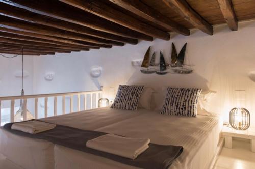 a bedroom with a large bed with sails on the wall at Apollonion house in Apollonia