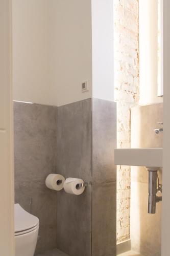 a bathroom with a toilet and two rolls of toilet paper at Kissinger in Detmold