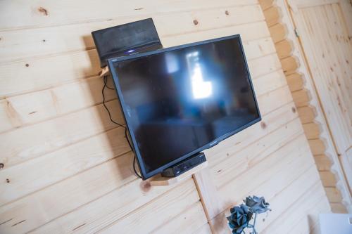 a television hanging on a wall in a room at FamilyCamp in Zator