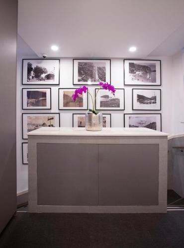 a white counter with purple flowers in a vase on it at Casa Mia in Budva