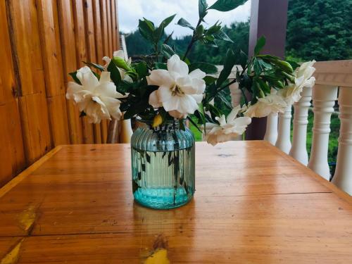 a vase filled with white flowers sitting on a table at Tongfu Inn(In the National Park) in Zhangjiajie