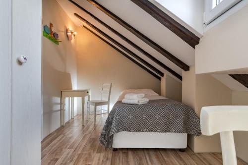a small bedroom with a bed and a table at Casa Carminatti Apartments in Split