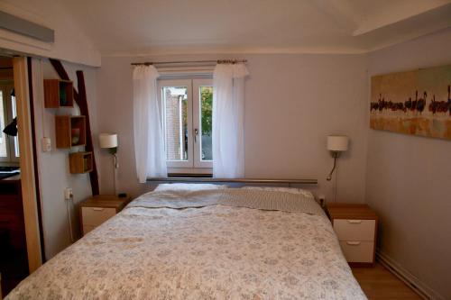 a bedroom with a bed and a window at Het Mergelhoek 2 in Vaals
