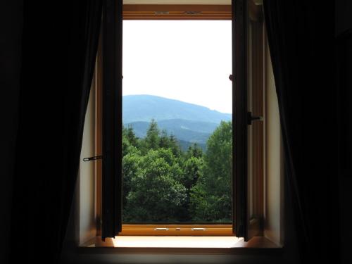 a window with a view of a mountain at Apartmány na hájovně in Jeseník