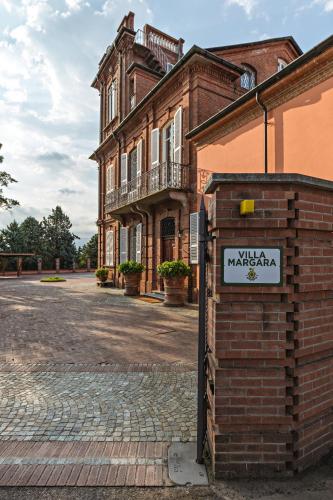 a brick building with a sign in front of it at Golf Club Margara in Fubine