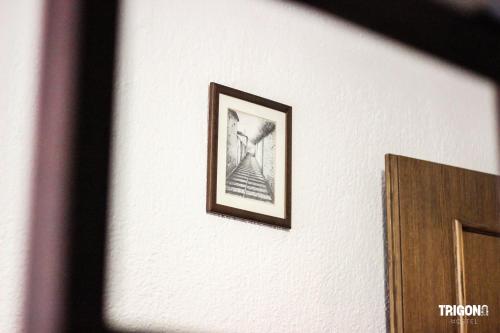 a picture on a wall with a picture on it at Trigona Guest House & Hostel in Gjirokastër