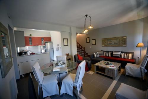 a living room with a table and a couch at Heliades Maisonettes in Mithymna