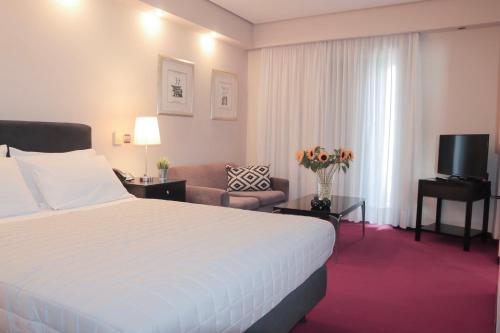 Ένα ή περισσότερα κρεβάτια σε δωμάτιο στο Hotel Victory