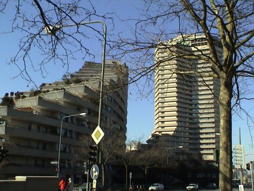 two tall buildings on a city street with a traffic light at Guestroom with wide view and pool near city side, 2nd guest with extra bed possible in Frankfurt/Main
