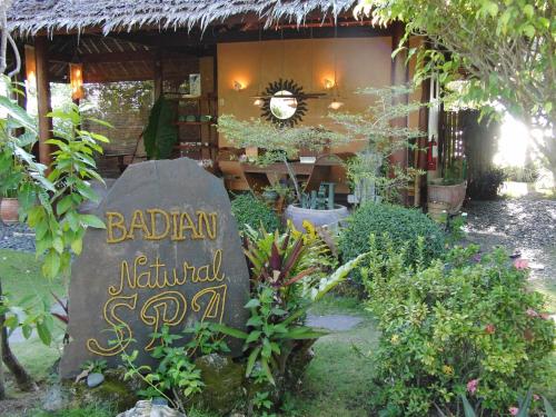 a sign in front of a building with aanical shop at Badian Island Wellness Resort in Badian