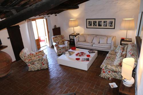 a living room with a couch and chairs and a table at La Cipressa in Greve in Chianti