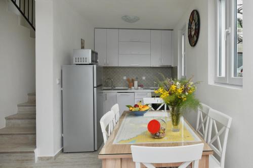 a kitchen with a table and a refrigerator at Hajdi in Kamenari
