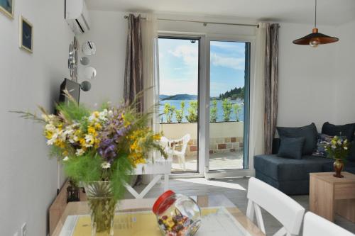 a living room with a vase of flowers on a table at Hajdi in Kamenari