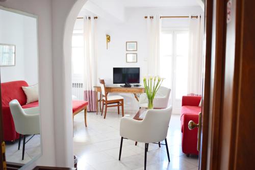 a living room with a table and chairs at Hotel Adonis in Mýkonos City
