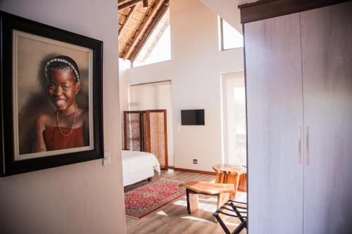 a room with a picture of a woman on the wall at Kuwisa Lodge in Bela-Bela