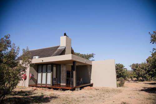a small house in the middle of a field at Kuwisa Lodge in Bela-Bela
