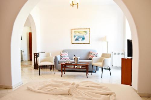 a living room with a couch and a table at Hotel Adonis in Mýkonos City