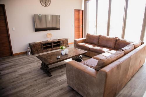 a living room with a couch and a coffee table at Kuwisa Lodge in Bela-Bela