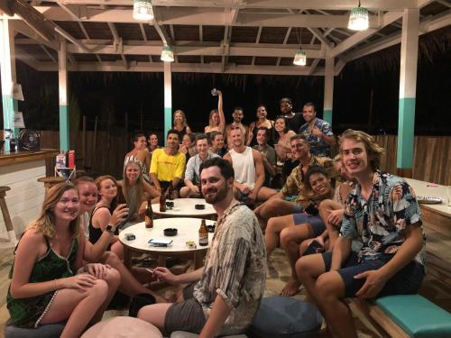 a group of people sitting around a table in a room at My Green Hostel in San Vicente