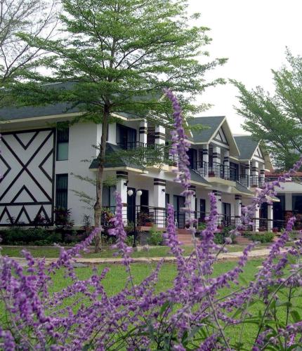 a house with purple flowers in front of it at Atunas Holiday Country in Dapu